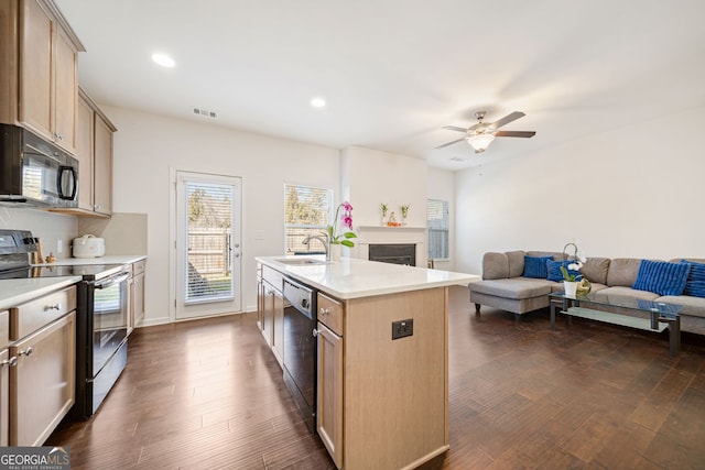 kitchen with electric range, dark wood finished floors, dishwasher, light countertops, and a sink