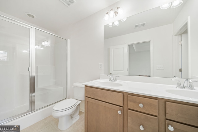 bathroom featuring visible vents, a sink, and double vanity