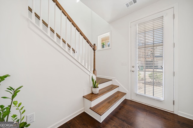 entryway featuring dark wood-style floors, stairway, visible vents, and baseboards