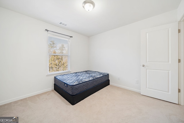 bedroom with carpet, visible vents, and baseboards