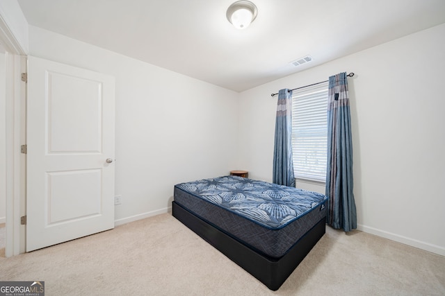 bedroom with carpet floors, baseboards, and visible vents