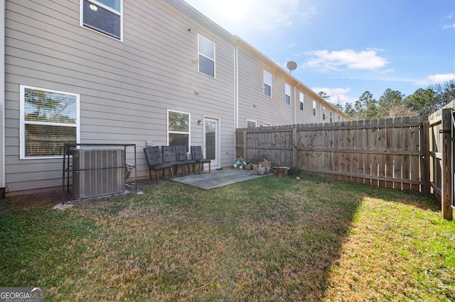 rear view of property featuring a fenced backyard, cooling unit, a patio, and a yard