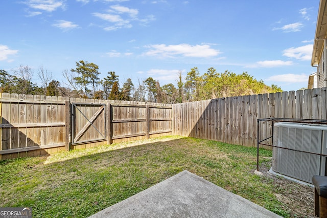 view of yard featuring central AC unit and a fenced backyard