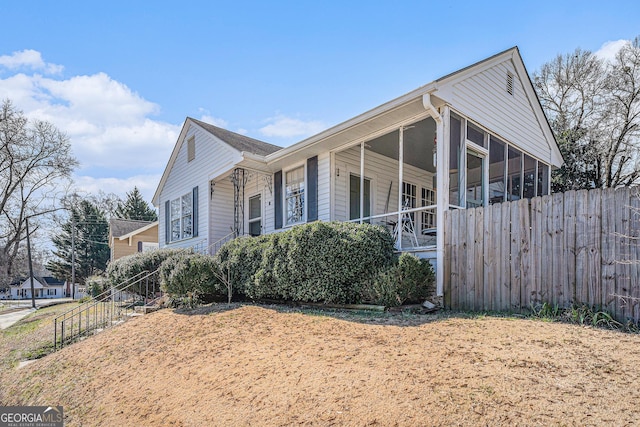 view of home's exterior featuring fence