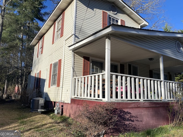 view of home's exterior with central AC and a porch