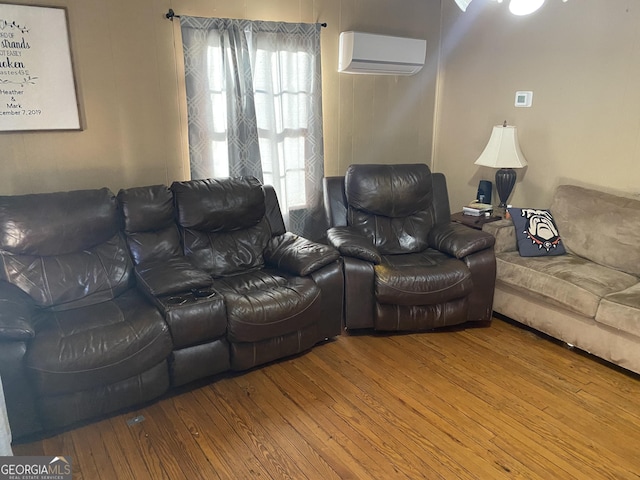 living room with hardwood / wood-style floors and a wall mounted air conditioner