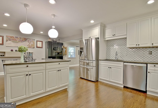 1453 Midview Dr, Decatur, GA 30032 - kitchen with light wood finished floors, appliances with stainless steel finishes, a sink, and decorative backsplash