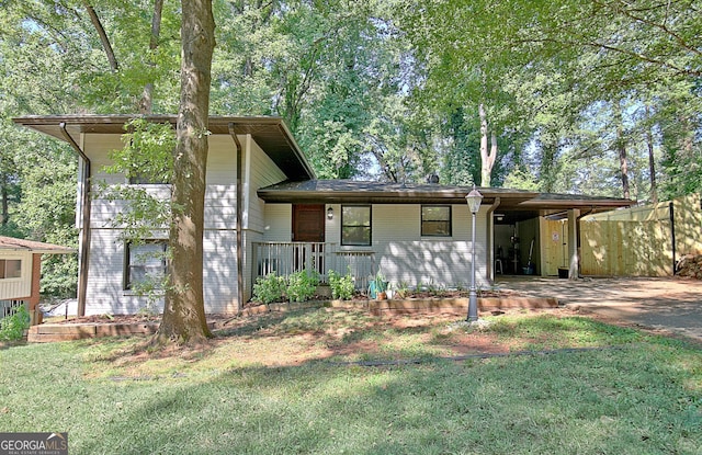 split level home featuring a carport, concrete driveway, and a front yard