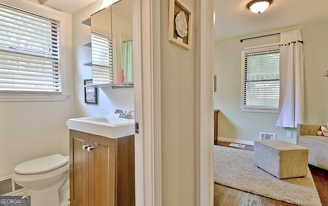 1453 Midview Dr, Decatur, GA 30032 - bathroom with visible vents, vanity, toilet, and a healthy amount of sunlight