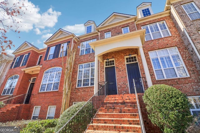 townhome / multi-family property featuring brick siding