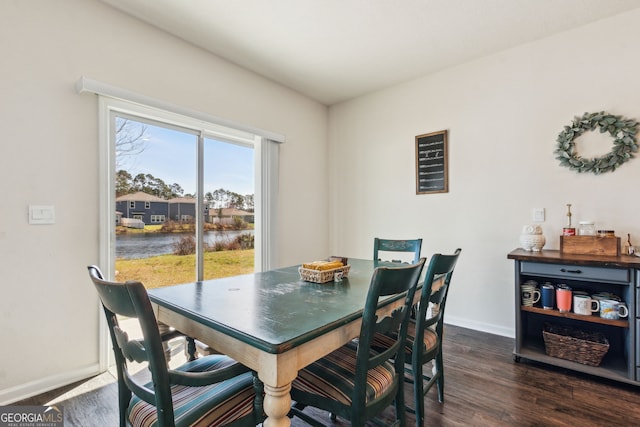 dining space featuring baseboards and dark wood-type flooring