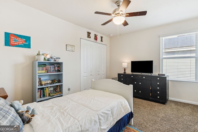 carpeted bedroom with a closet, ceiling fan, and baseboards