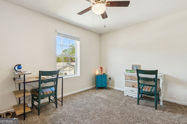 carpeted office featuring ceiling fan and baseboards