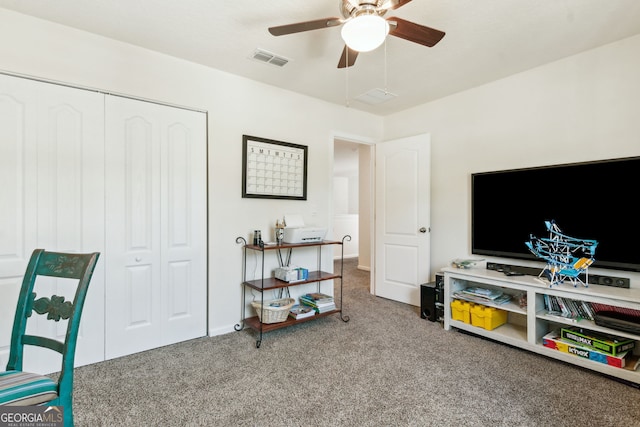 sitting room featuring ceiling fan, visible vents, and carpet flooring