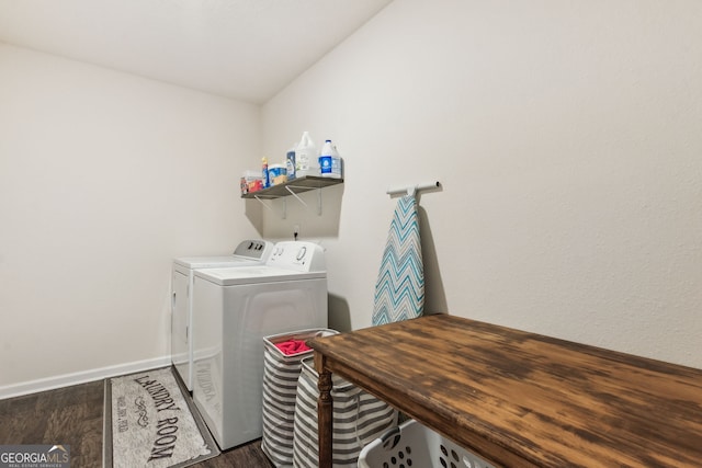 laundry room featuring laundry area, washer and clothes dryer, baseboards, and wood finished floors