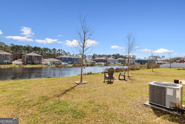 view of yard with a water view, a residential view, and cooling unit