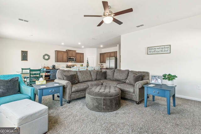 living room featuring light carpet, baseboards, visible vents, and recessed lighting