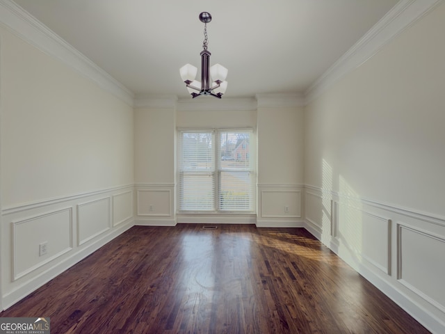 unfurnished dining area featuring a chandelier, dark wood-type flooring, crown molding, and a decorative wall