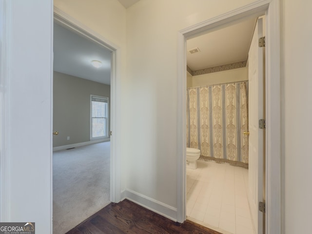 bathroom with toilet, baseboards, and visible vents