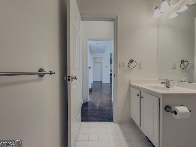 bathroom featuring tile patterned flooring, baseboards, and vanity