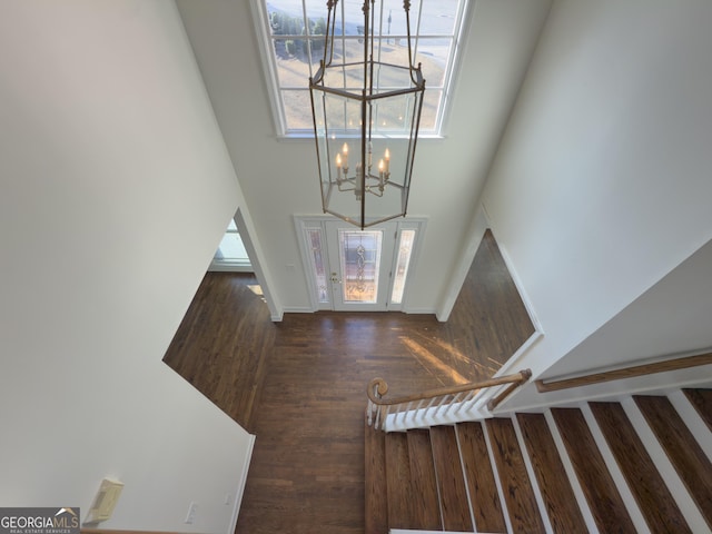 entrance foyer featuring a high ceiling and wood finished floors