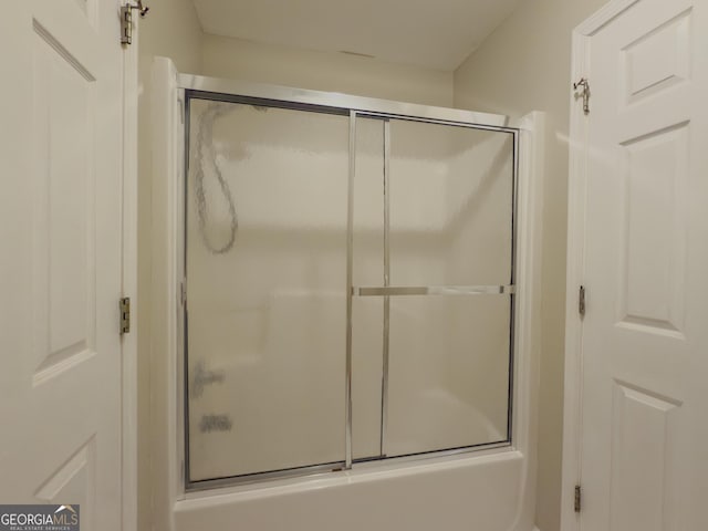 bathroom featuring shower / bath combination with glass door