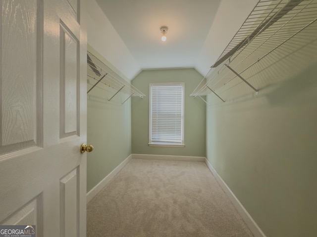 spacious closet featuring carpet floors and lofted ceiling