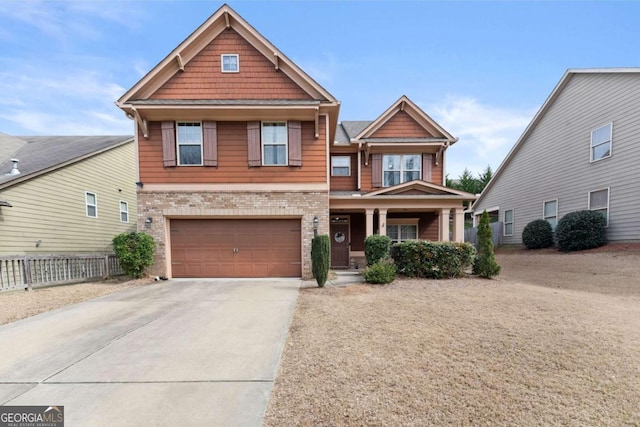 craftsman-style home with driveway, a garage, fence, a porch, and brick siding