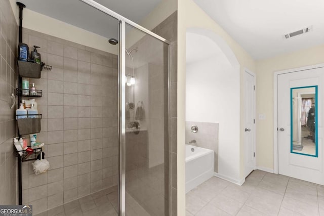 bathroom featuring a garden tub, tile patterned flooring, a shower stall, and visible vents