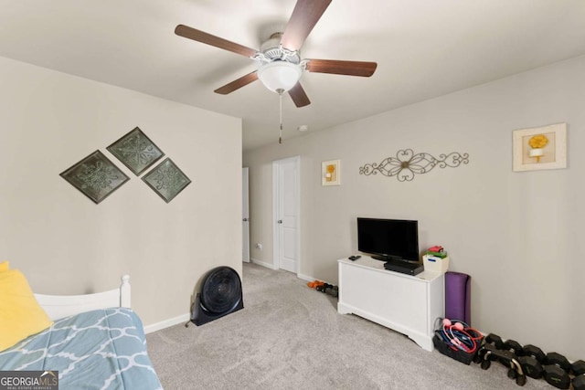 carpeted bedroom featuring ceiling fan and baseboards