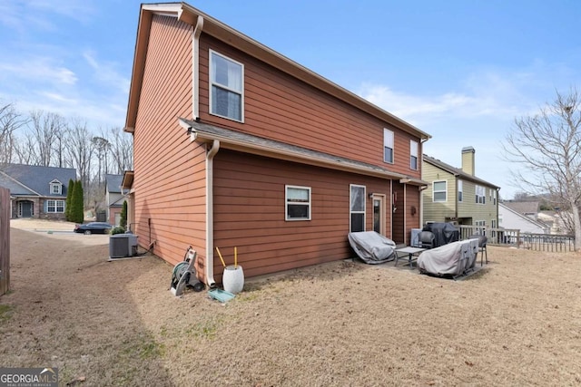 back of property featuring cooling unit and fence