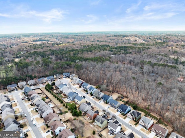 aerial view featuring a residential view and a wooded view