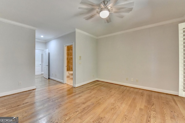 spare room featuring light wood-style floors, crown molding, baseboards, and a ceiling fan