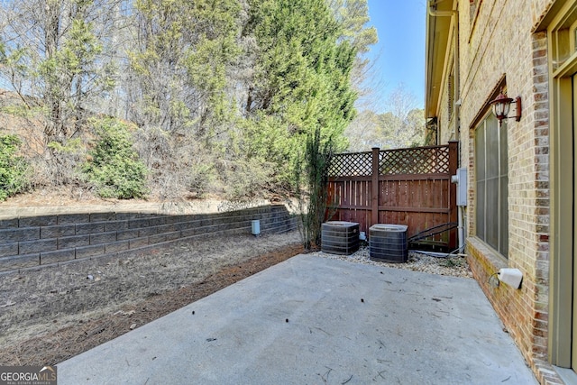 view of patio with fence and central AC unit