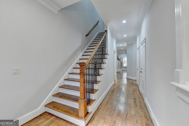 staircase with baseboards, recessed lighting, wood finished floors, and crown molding