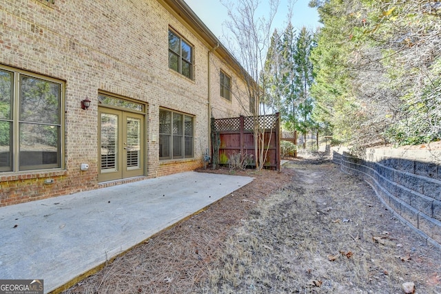 view of yard with french doors, a patio area, and fence