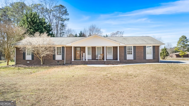 single story home featuring covered porch, brick siding, crawl space, and a front yard