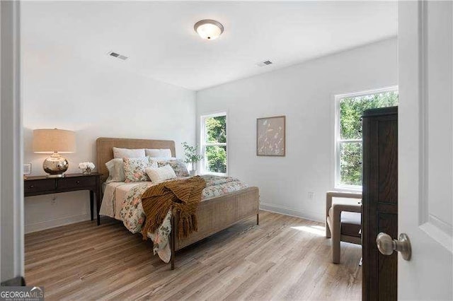 bedroom featuring light wood-style flooring and baseboards