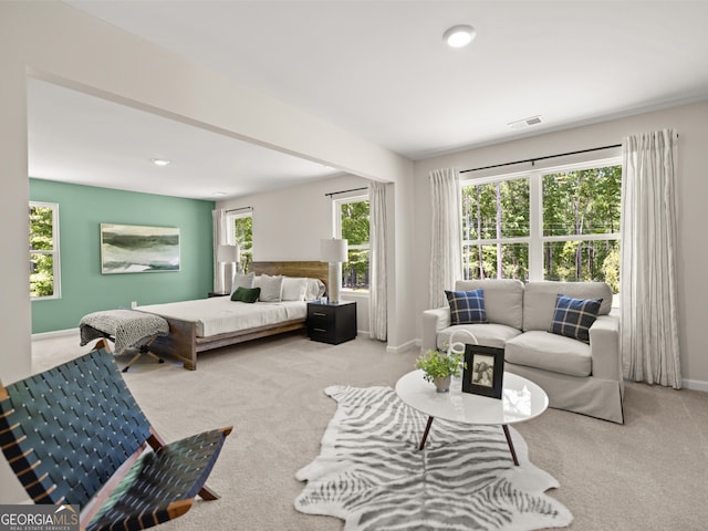 carpeted bedroom with visible vents and baseboards