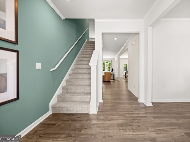 interior space with crown molding, stairs, baseboards, and wood finished floors