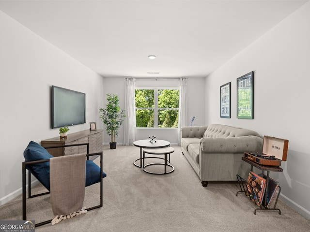 carpeted living area featuring visible vents and baseboards