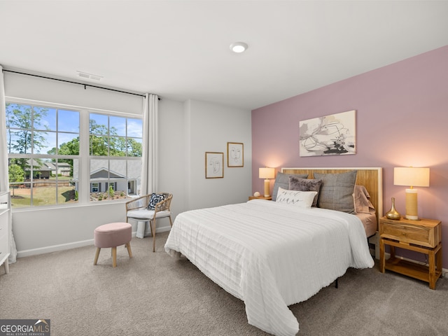 bedroom featuring baseboards, visible vents, and carpet flooring