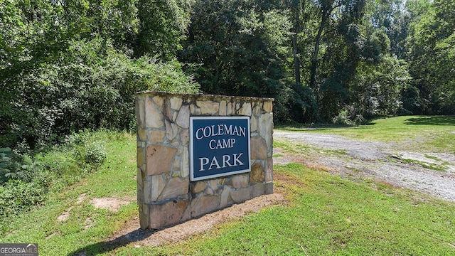 community sign featuring a lawn