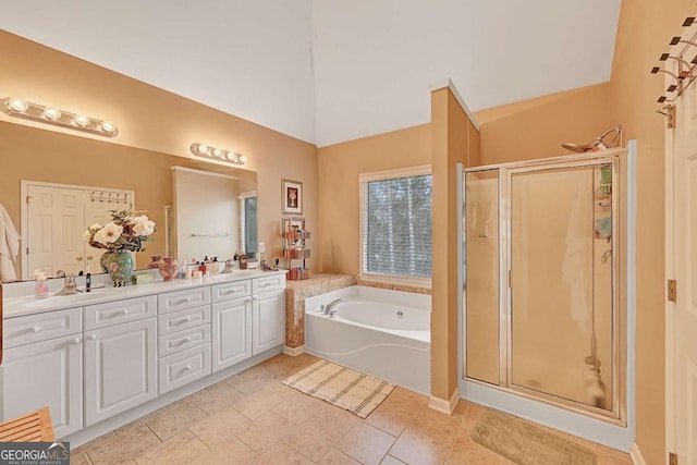 full bathroom featuring a sink, a shower stall, a bath, tile patterned floors, and double vanity