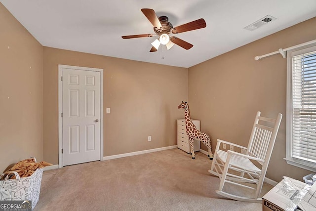 unfurnished room featuring light carpet, baseboards, visible vents, and ceiling fan