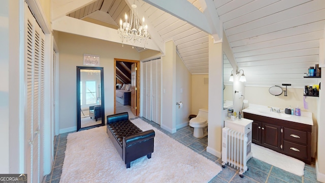 bathroom featuring a notable chandelier, vaulted ceiling with beams, radiator, toilet, and vanity