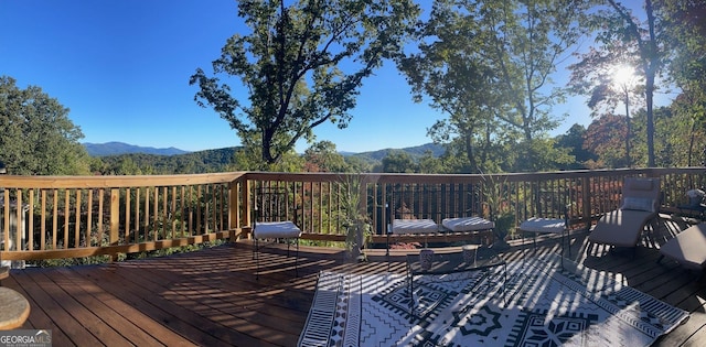 wooden deck with a mountain view