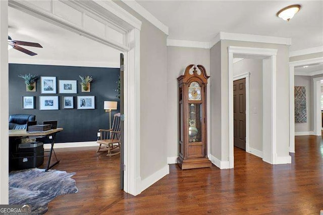 entrance foyer with crown molding, baseboards, ceiling fan, and wood finished floors