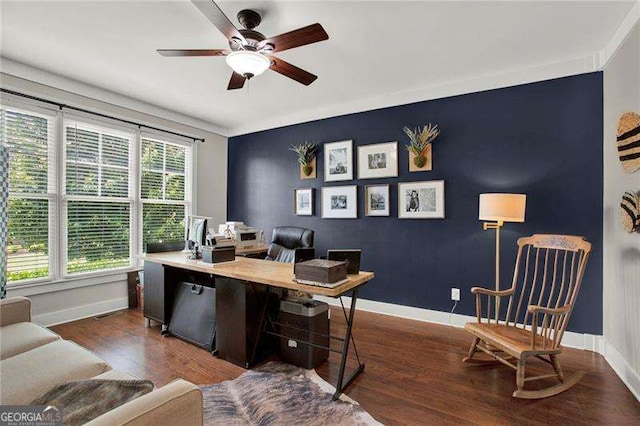 office space with an accent wall, baseboards, and wood finished floors