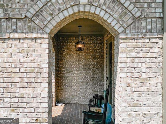 entrance to property featuring brick siding